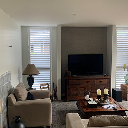 Shutters add balance to this room as well as privacy