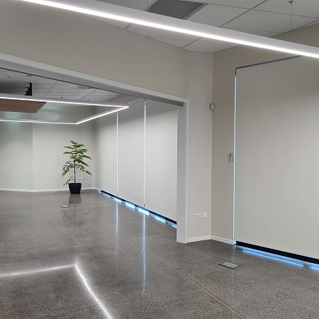 Block Out Roller Blinds Covering Large Windows In A Commercial Building